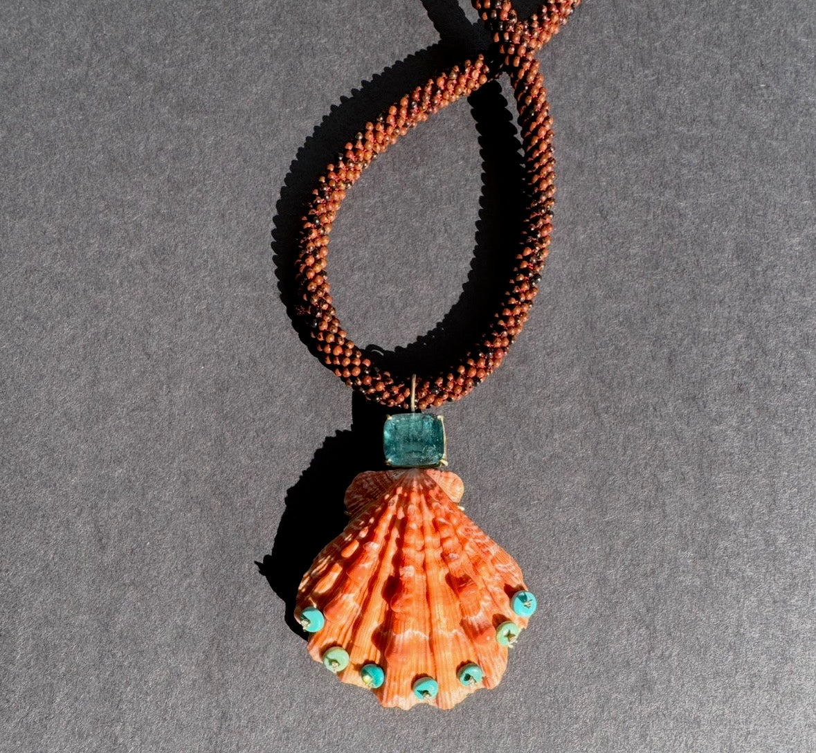 Lions Paw Shell with Tourmaline, Diamonds and Turquoise on Jasper embroidered cord