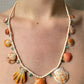 Orange Shells, Emeralds and Tourmalines on Shell Beads